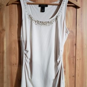 Cream colored sleeveless shirt with beaded accents